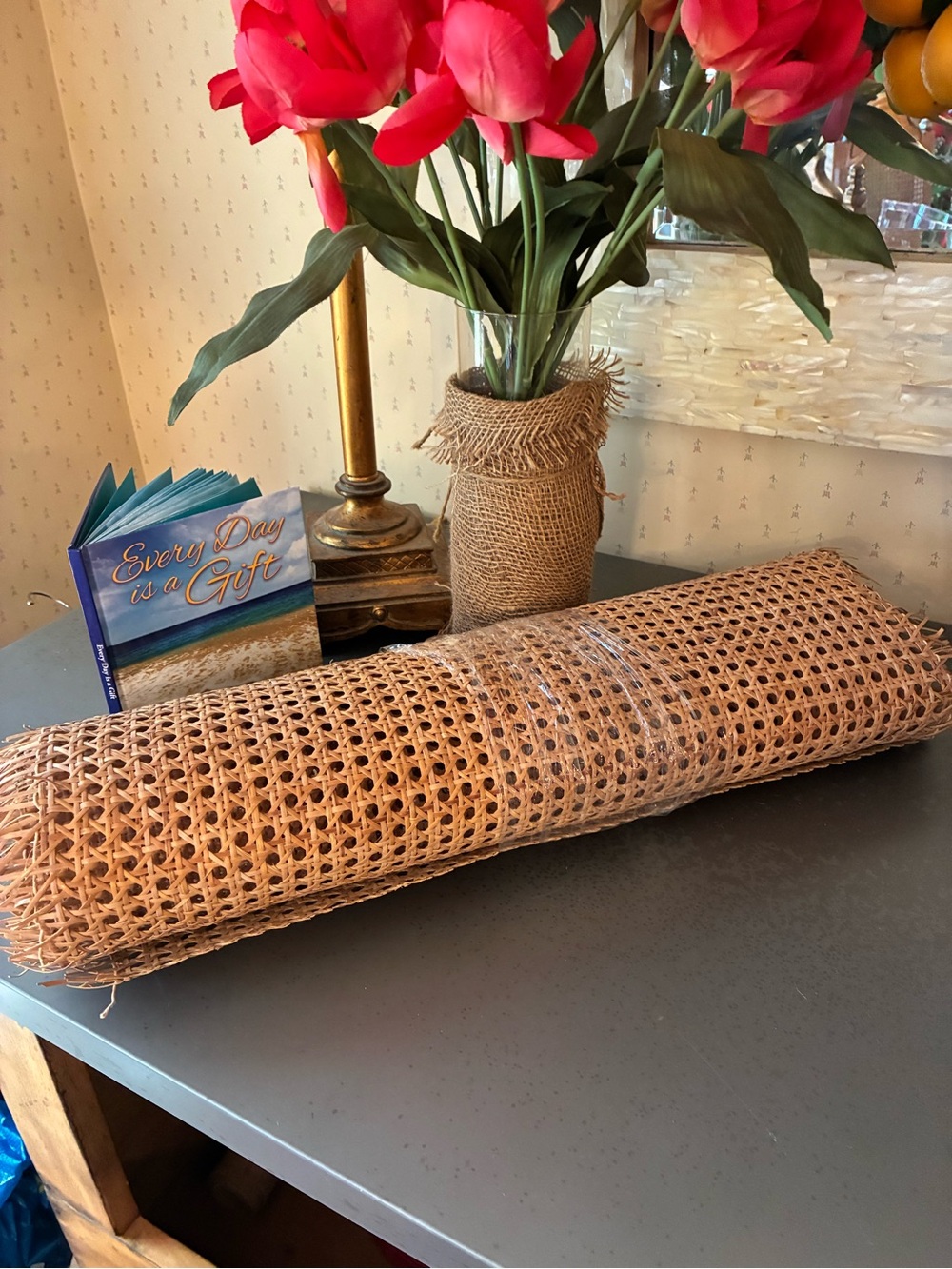 A piece of Natural Rattan Cane Webbing, open hexagonal mesh weave.